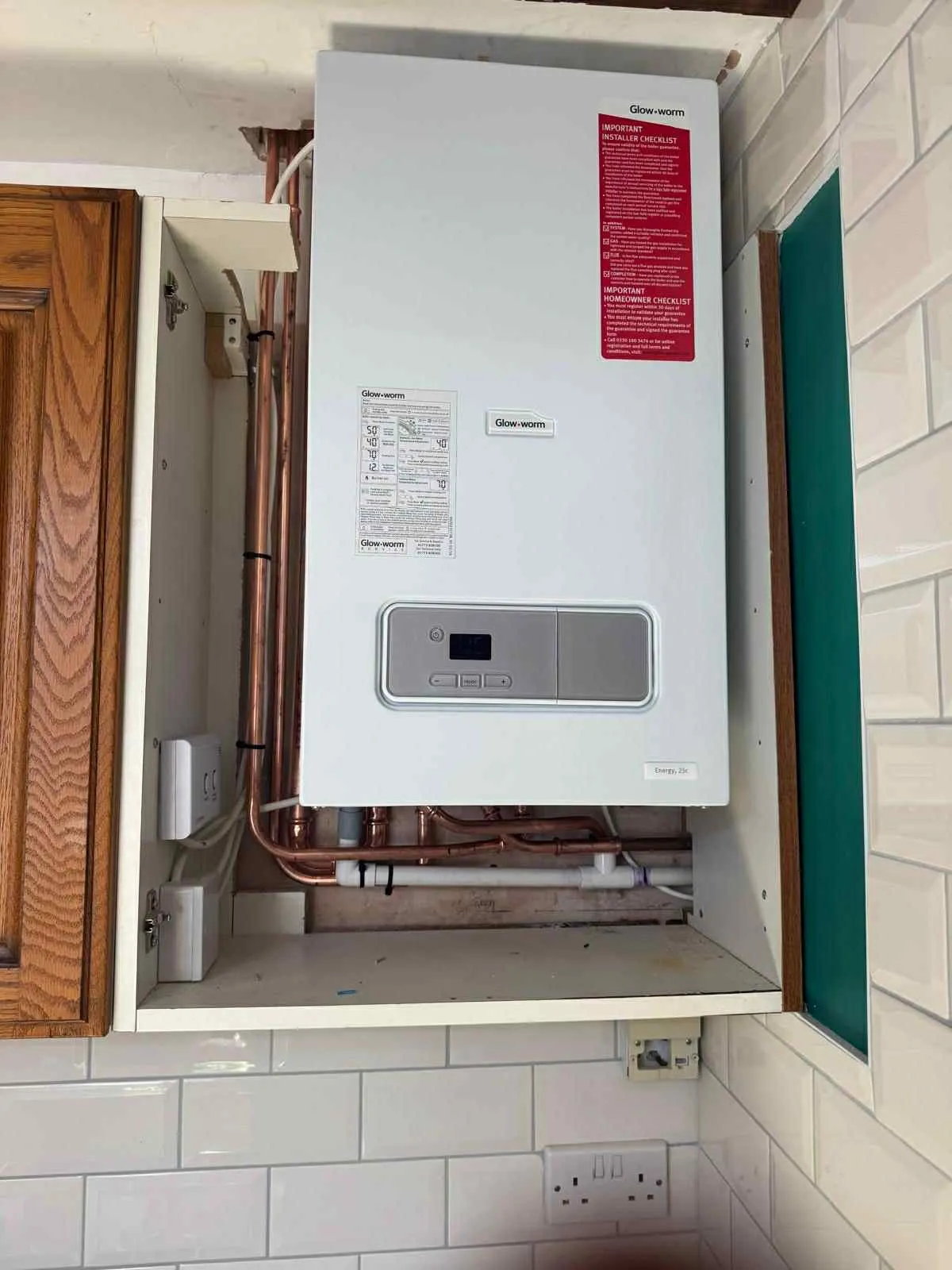A new boiler fitted in a kitchen cupboard
