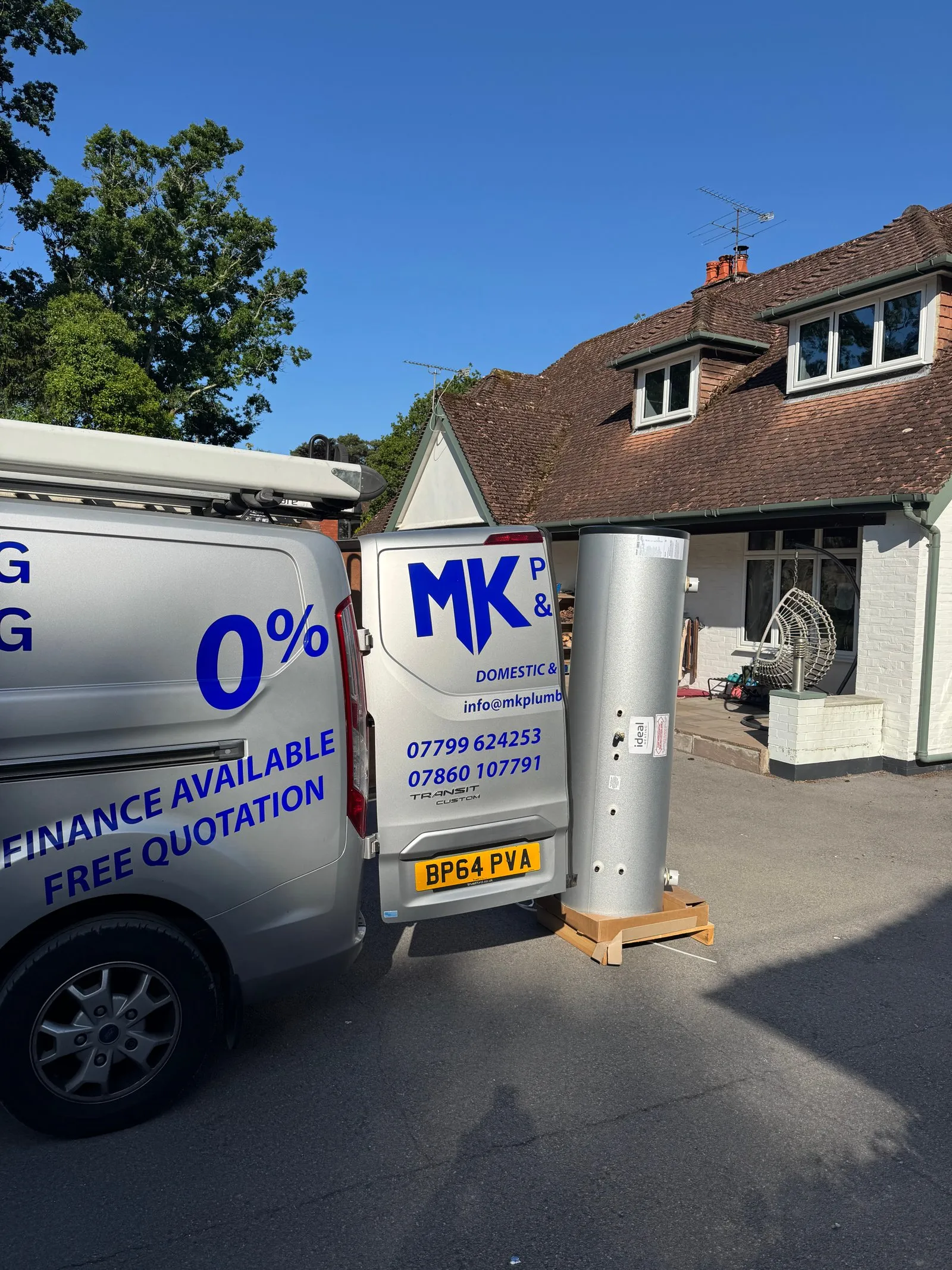 The MK Plumbing & Heating van on a customer’s drive, with a new hot water cylinder ready to go in